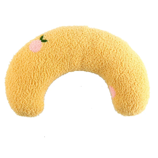 Yellow half-moon cat pillow with an embroidered peach